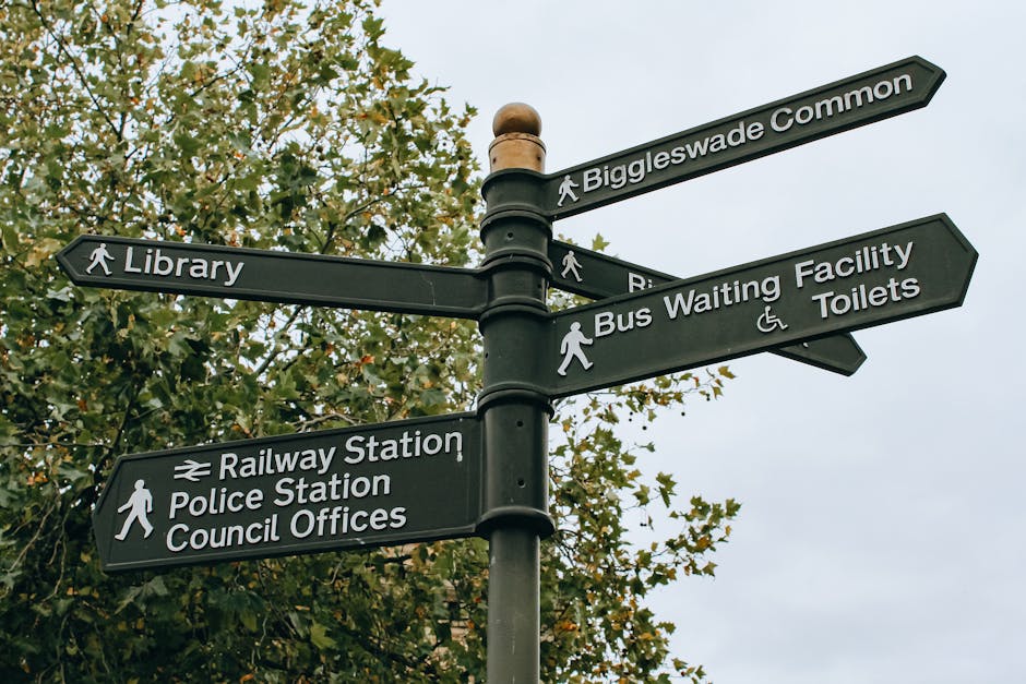 A rectangular metal sign mounted on a red brick wall, with black text on a white background reading 'NO DUMPING OF RUBBISH' in uppercase letters. The sign appears weathered with some minor scratches a